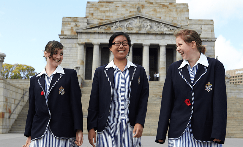 Three female school students walking at the Shrine of Remembrance