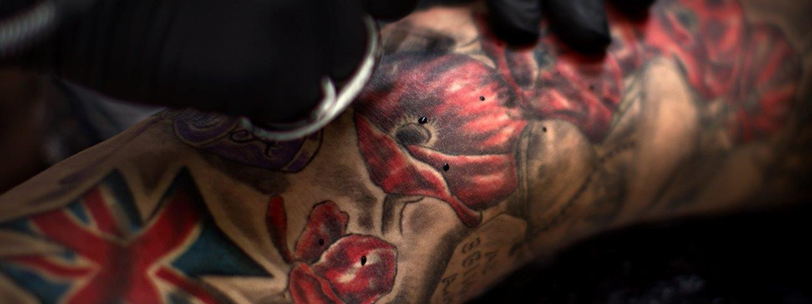 Close up image of an arm being tattooed