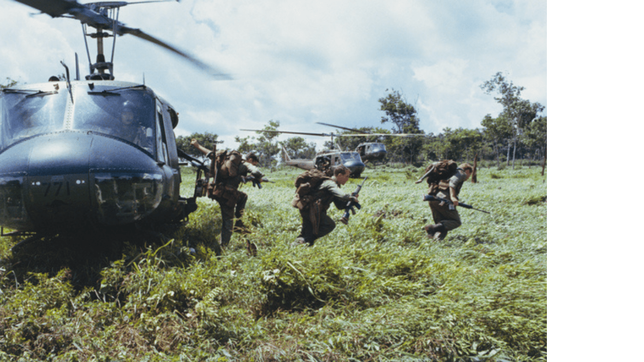 Soldiers of 6RAR and New Zealand ANZAC alighting from a UH-1H Iroquois helicopter to set up a memorial cross and hold a commemorative service at the Long Tan battle site